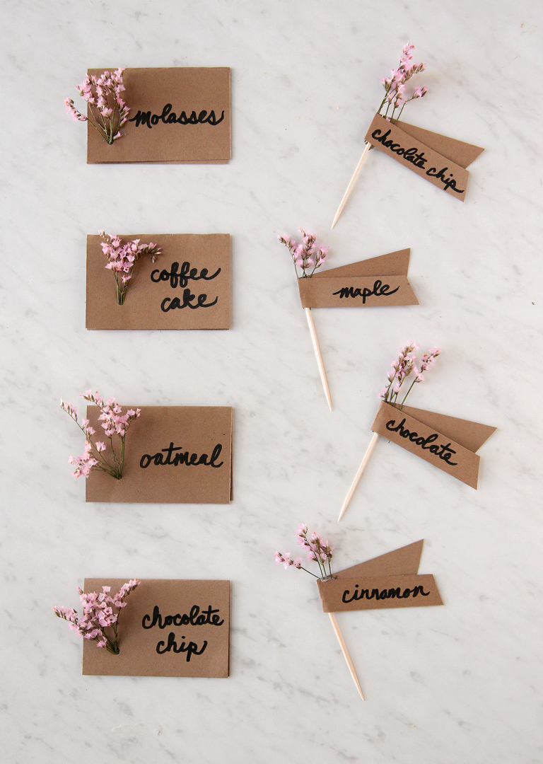 folded card and toothpick DIY floral food labels sitting on marble board
