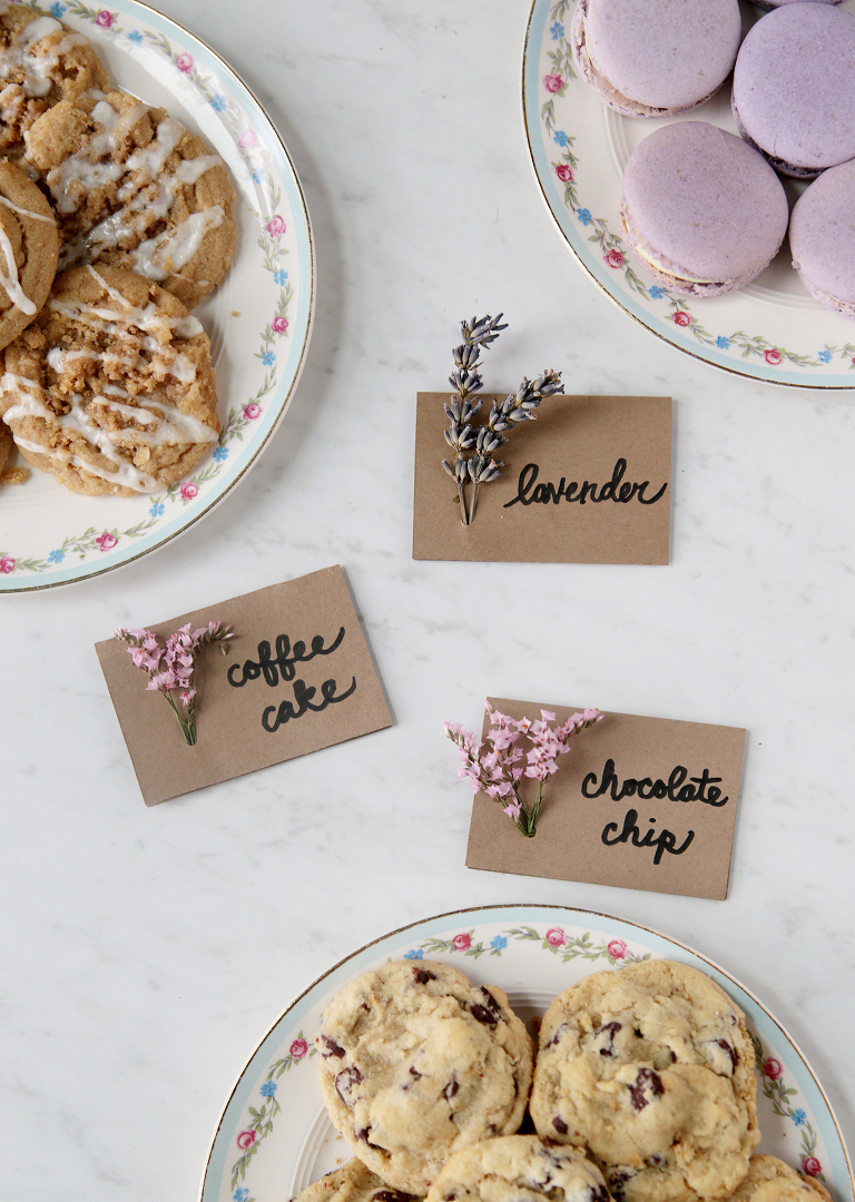 three plates of cookies with flower food labels next to plates