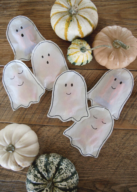 diy ghost treat tons laying on wood table with pumpkins virtually them