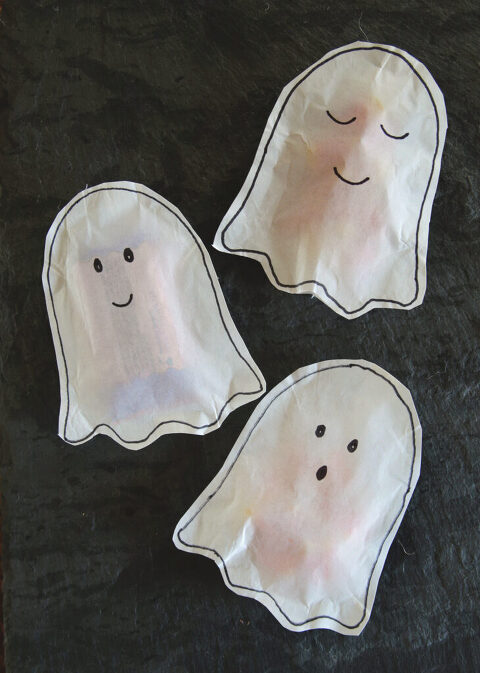 three white paper ghost treat tons on visionless gray stone