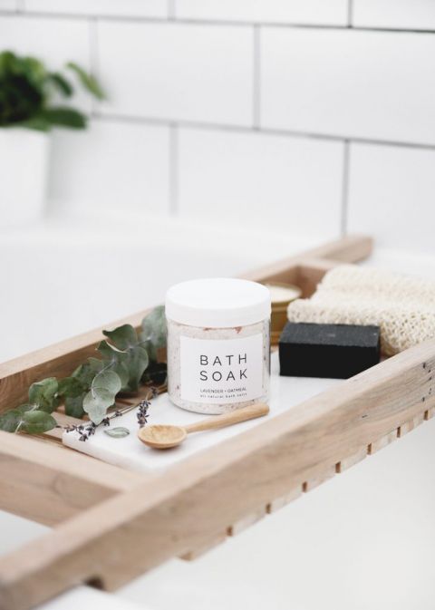 jar of bath soak on wood bath tub tray