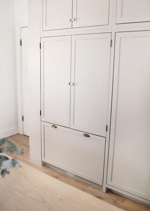 beige cabinet refrigerator with wood knobs and brass handles
