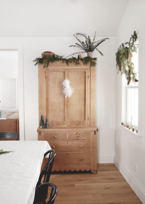 wood cabinet in dining with christmas decor on it