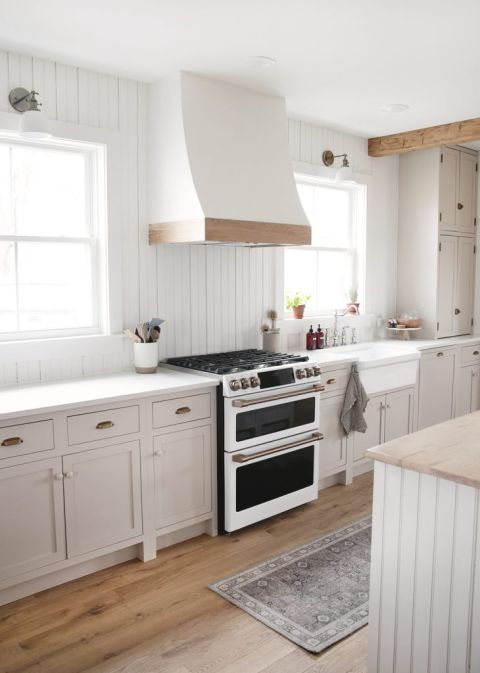 kitchen with beige cabinets and white and wood range hood cover over range