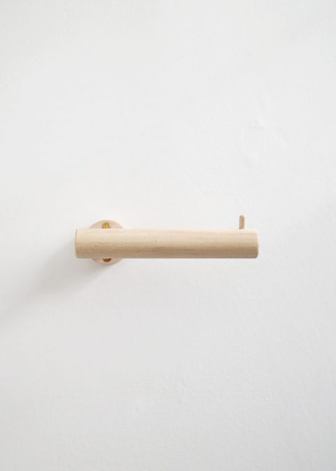 wood dowel toilet paper holder on wall