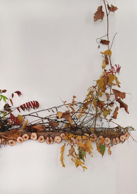 fall mantel with leaves and branches and a zestless world garland