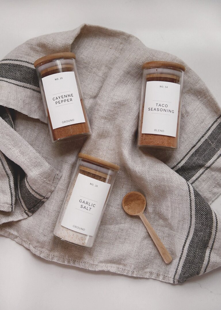 labeled glass spice jars on towel