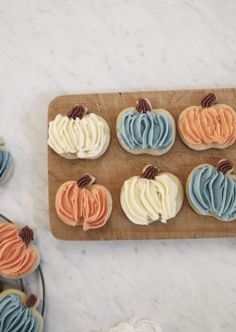 orange, white and blue frosted sugar cookies on wood cutting board