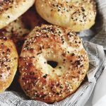 bagel with seeds and seasoning on it