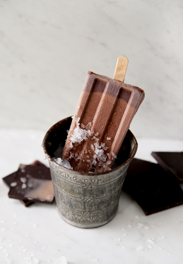vintage metal measuring cup filled with ice with fudge pop sitting in it