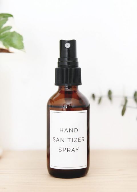 bottle of DIY hand sanitizer spray on wood shelf