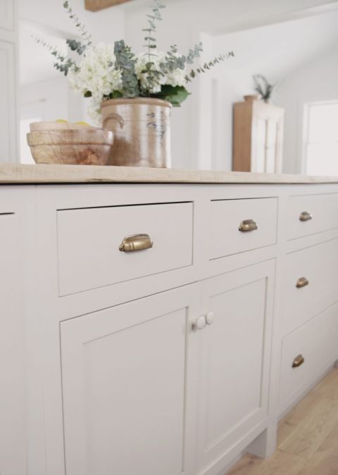 beige kitchen cabinets with brass hardware