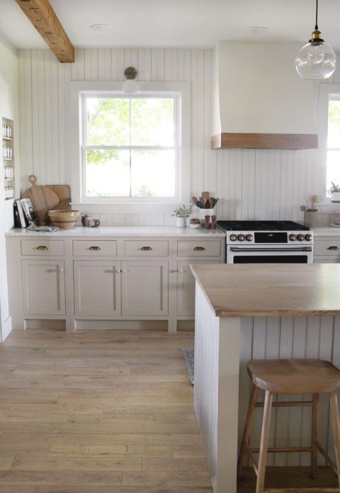 kitchen with wood floor and beadboard wall and beadboard kitchen island