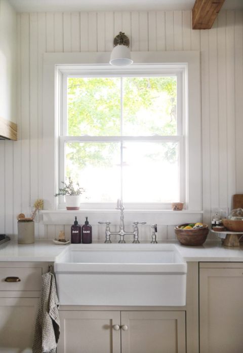 farmhouse kitchen sink wtih beadboard wall behind sink