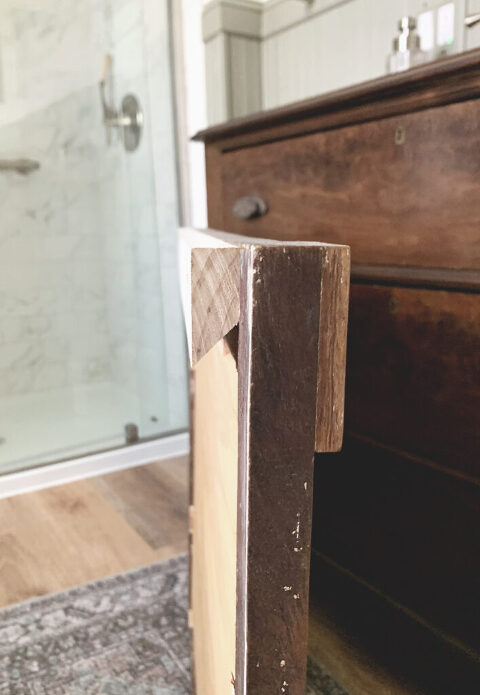 side view of wood frame mirror with a french cleat on when of mirror