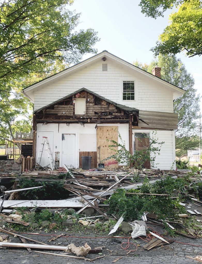 side of house with part of it torn down