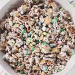 large bowl of lucky charms white chocolate snack mix on top of rainbow dish towel