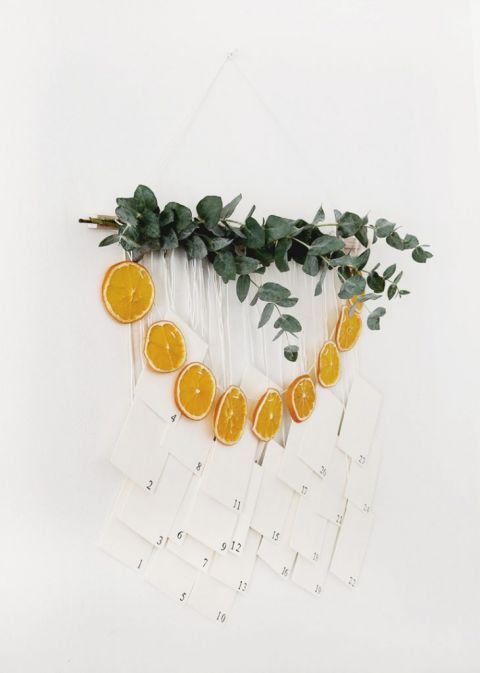 wall hanging with eucalyptus, dried oranges and numbered envelopes