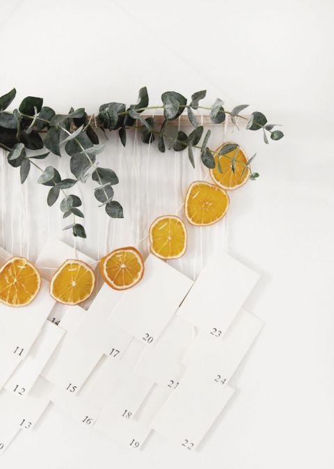 wall hanging with eucalyptus, dried oranges and numbered envelopes