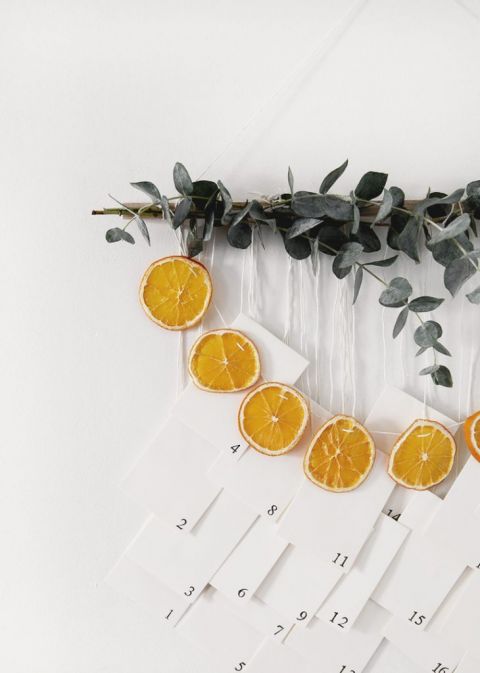 wall hanging with eucalyptus, dried oranges and numbered envelopes