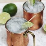 two moscow mule mocktails in copper mugs