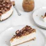 slice of no bake peanut butter cheesecake on a white plate