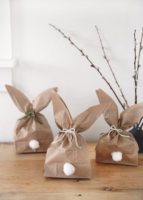 3 brown paper bag bunnies on shelf next to pussy willows