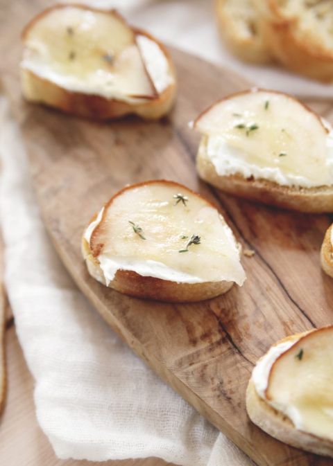 crostini with goat cheese, pear slices, honey drizzle and thyme