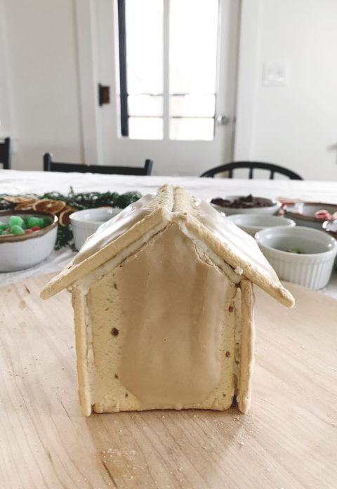 plain pop tart gingerbread house on wood wearing board