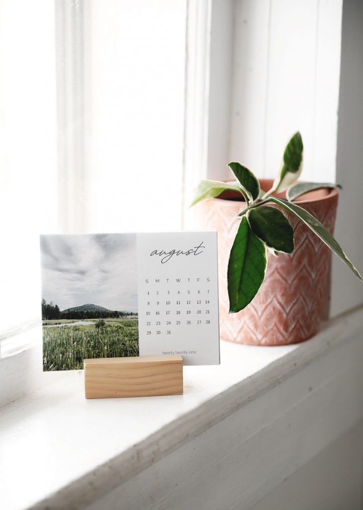 printable photo calendar on shelf next to plant