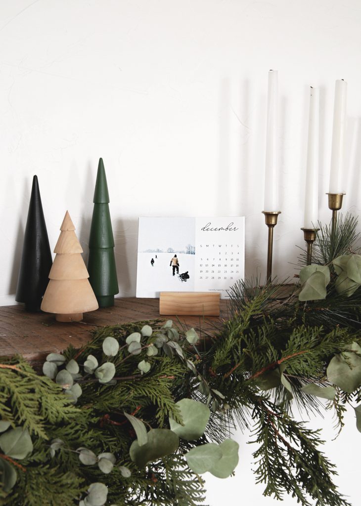calendar on wood mantel with christmas decor