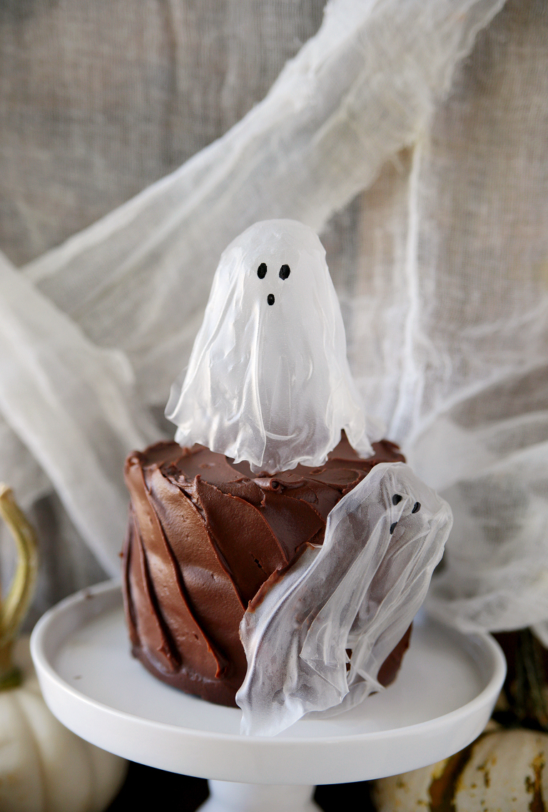 rice paper ghost on top of chocolate cake and another ghost on side of cake