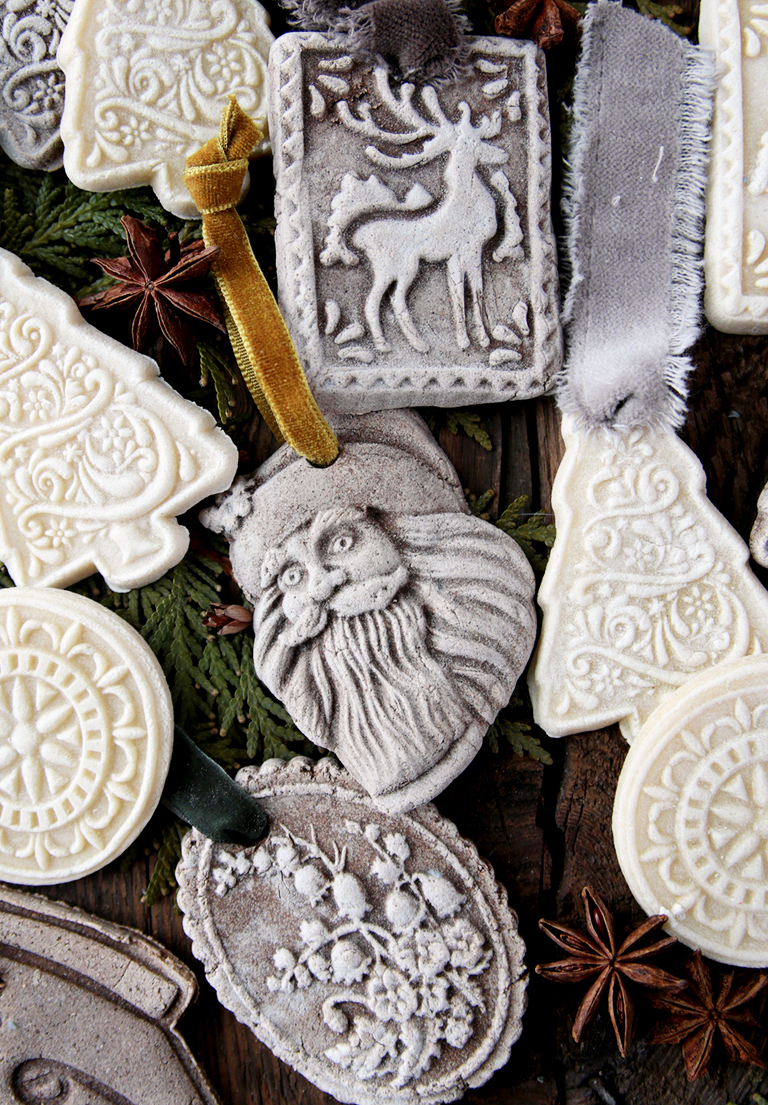 santa salt dough cookie mold ornament laying on board next to other salt dough ornaments