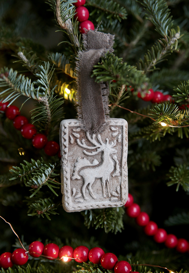 gingerbread deer christmas ornament hanging on tree branch