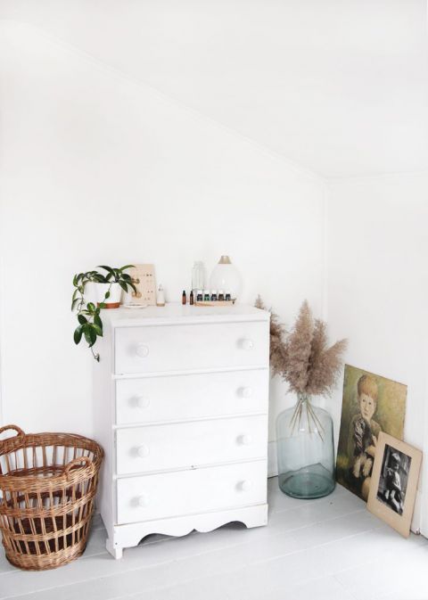 white dress next to basket and dried seagrass