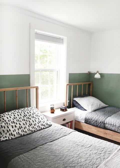 two twin wood beds in green and white room