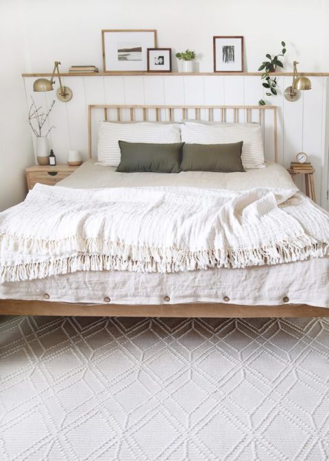 bedroom with wood bed and cream wool rug