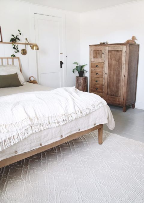 bedroom with creamy wool rug and antique dresser