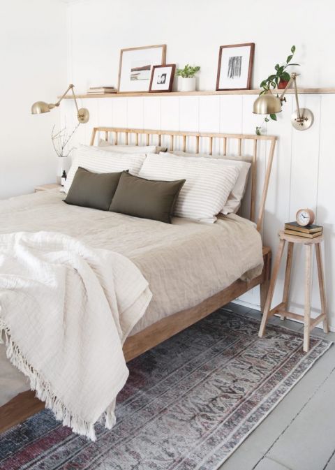 bedroom with wood bed frame and wood shelf above bed