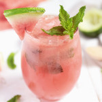 glass filled with blended watermelon mojito mocktail topped with watermelon slice and mint leaves