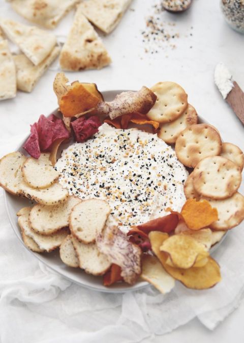 dip on plate with pita crackers and bagel chips around it