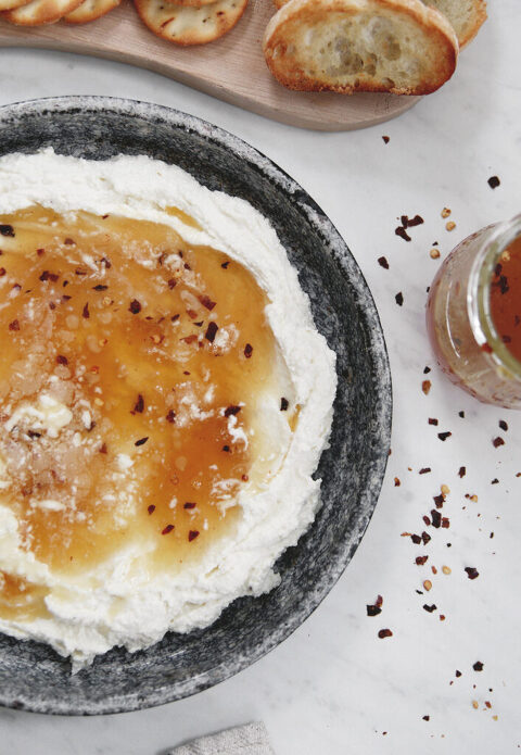 whipped feta with hot honey dip in a metal pie plate