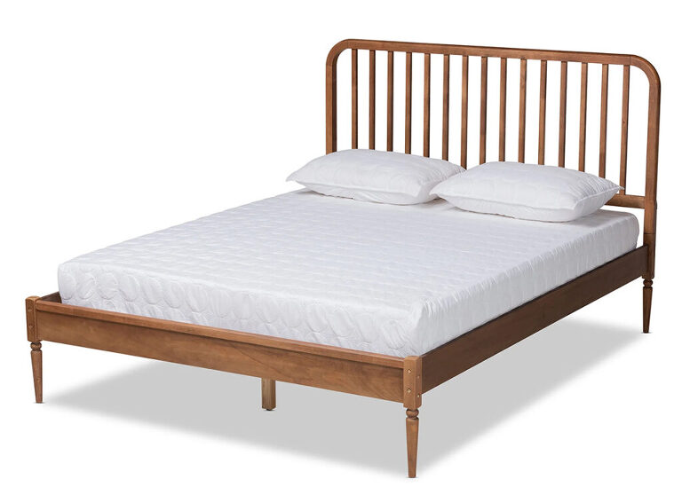 a dark wood spindle bed