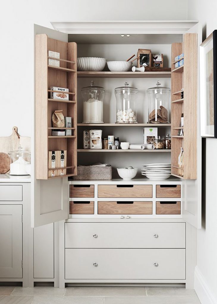 pantry cupboard opened showing organized shelves and drawers